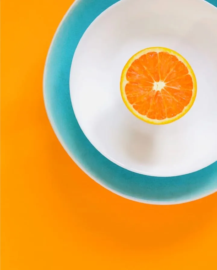 orange sliced in half in a plate